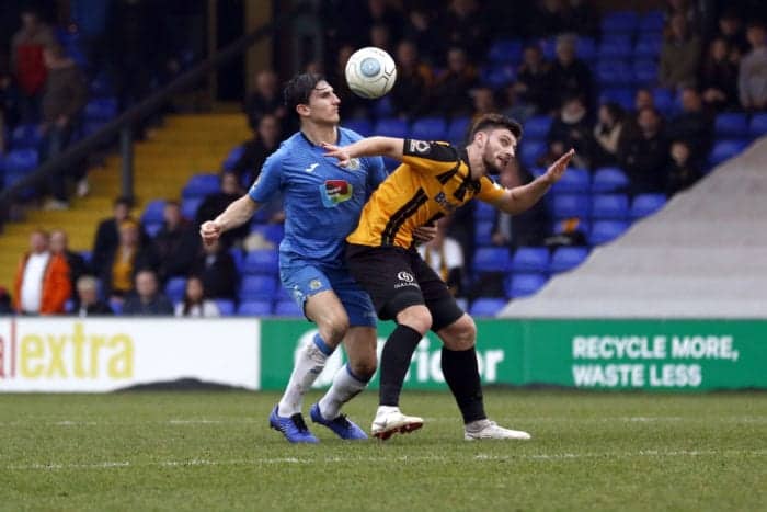 Ash Palmer challenges for the ball for Stockport